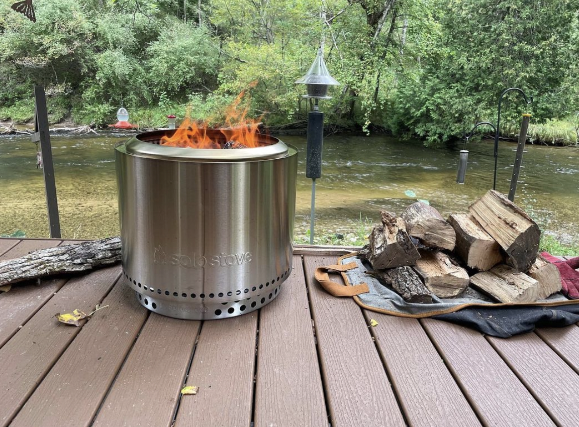 Solo Stove Fire Pit Burning an Open Flame on a Dock by a Lake